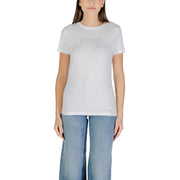 Woman wearing white short-sleeve T-shirt with light blue wide-leg jeans for Guess Active collection