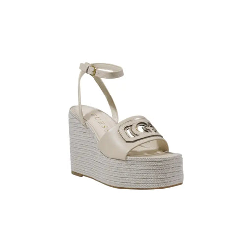 Cream-colored Guess wedge sandal with woven espadrille sole and metallic logo accent in beige with buckle and bow detail