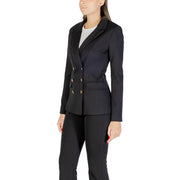 Women wearing Guess long black V neck blazer and matching trousers for fall winter fashion