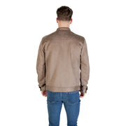 Men’s light brown suede-like blazer with zip front and buttoned cuffs over blue jeans