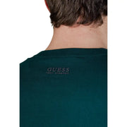 Dark green guess men knitwear tech stretch t-shirt with a subtle embroidered logo at the neckline in viscose blend