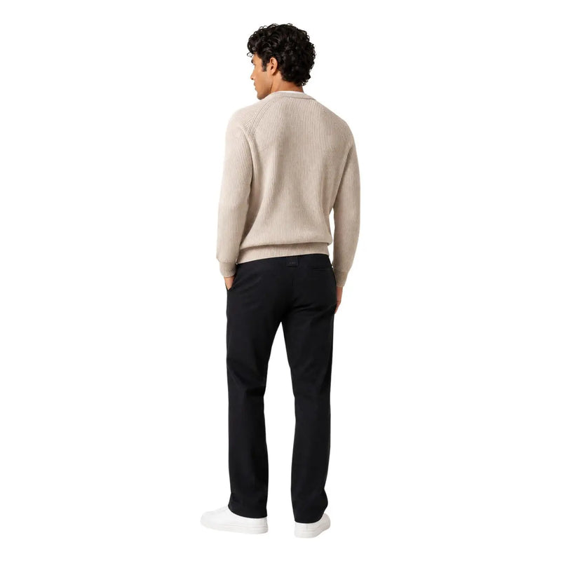Beige ribbed knit sweater with long sleeves and crew neckline paired with Guess men regular leg black cotton trousers