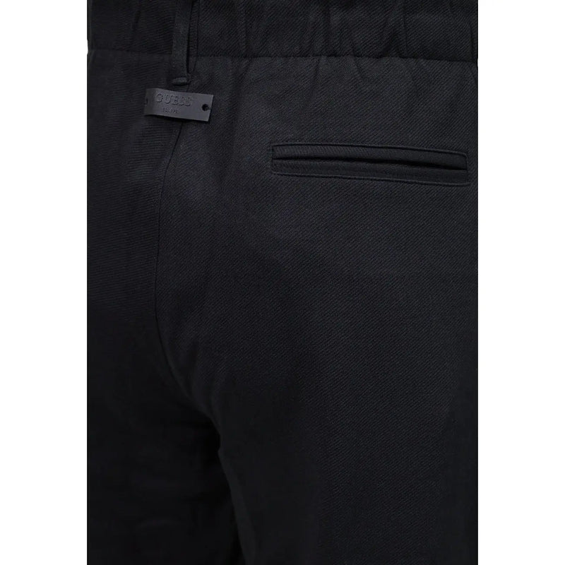 Guess men regular leg black cotton trousers with subtle woven pattern and branded label on waistband
