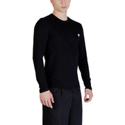 Guess men black long-sleeved crewneck sweater featuring a small pink triangular logo on the left chest