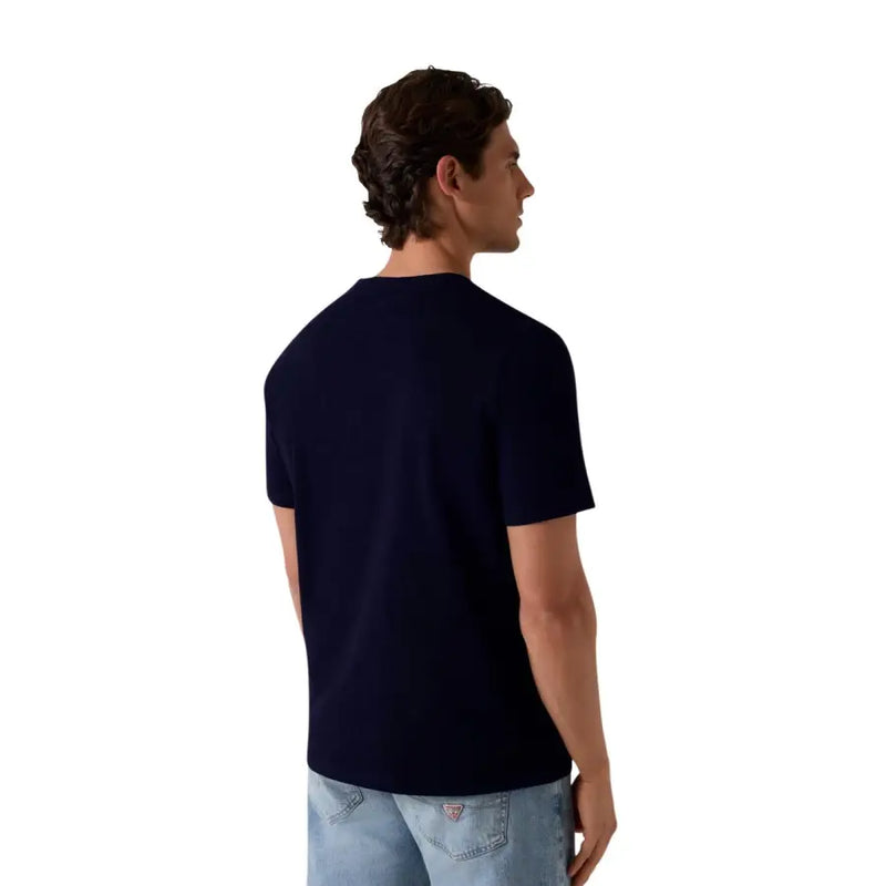Navy blue Guess men t shirt in cotton modal blend showing back side with subtle logo on lower back pocket