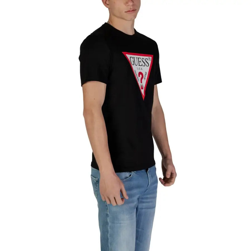Guess men t-shirt in black featuring a bold red and white triangular logo on the chest for casual wear