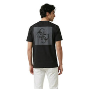 Back of black Guess men t-shirt with gray rectangular patch featuring intricate black monogram design