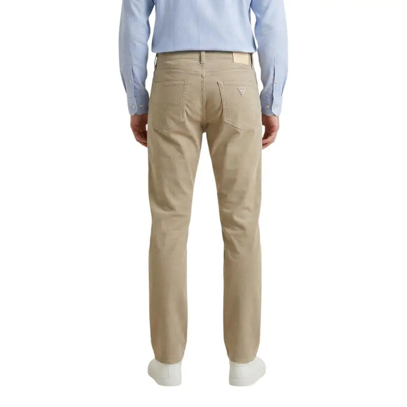 Beige guess men trousers made of cotton blend showing the back side with classic five-pocket design and subtle logo