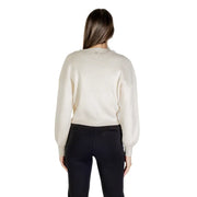 Woman wearing a cream ribbed long-sleeve sweater and black pants showcasing Guess Women Beige V Neck Long Cardigan