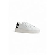 White Guess women sporty sneaker in faux leather with black heel accents and chunky white sole shown from the back