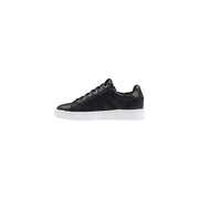Back view of guess women black print slip on sneakers with subtle gold logo on polyurethane heel and white sole