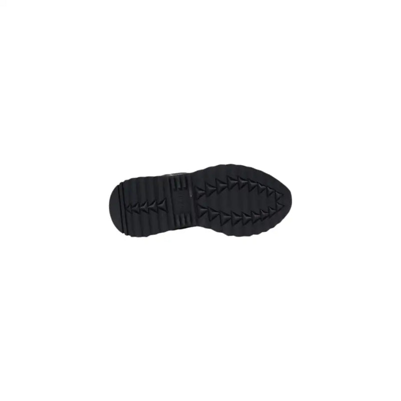 Black rubber sole with textured triangular tread pattern on the back of Guess women black sporty slip on sneakers