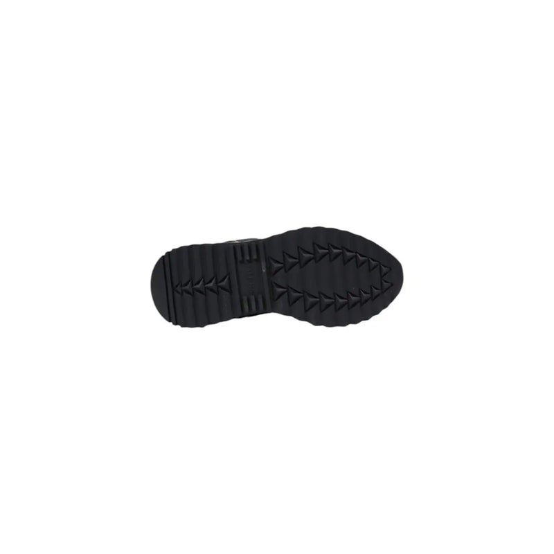 Black rubber sole with textured triangular tread pattern on the back of Guess women black sporty slip on sneakers