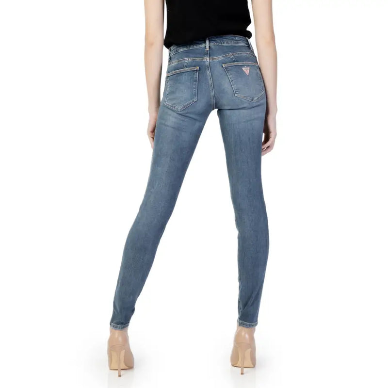 Back side of guess women blue slim fit denim jeans with subtle fading from fall winter collection showing logo pocket