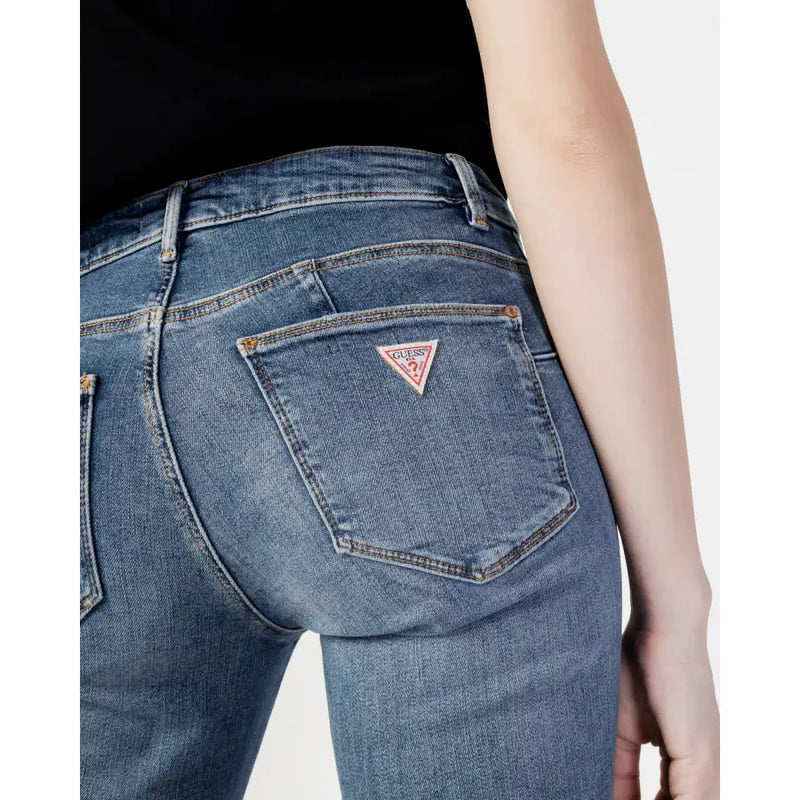 Back side of guess women blue plain denim jeans featuring a classic pocket with a pink triangular logo patch