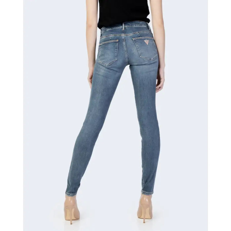 Back view of guess women blue slim-fit light-wash denim jeans with classic embroidered logo fall winter collection