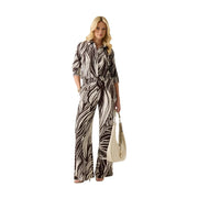 A woman wears a black and white zebra-print viscose jumpsuit with three-quarter sleeves and wide-leg pants