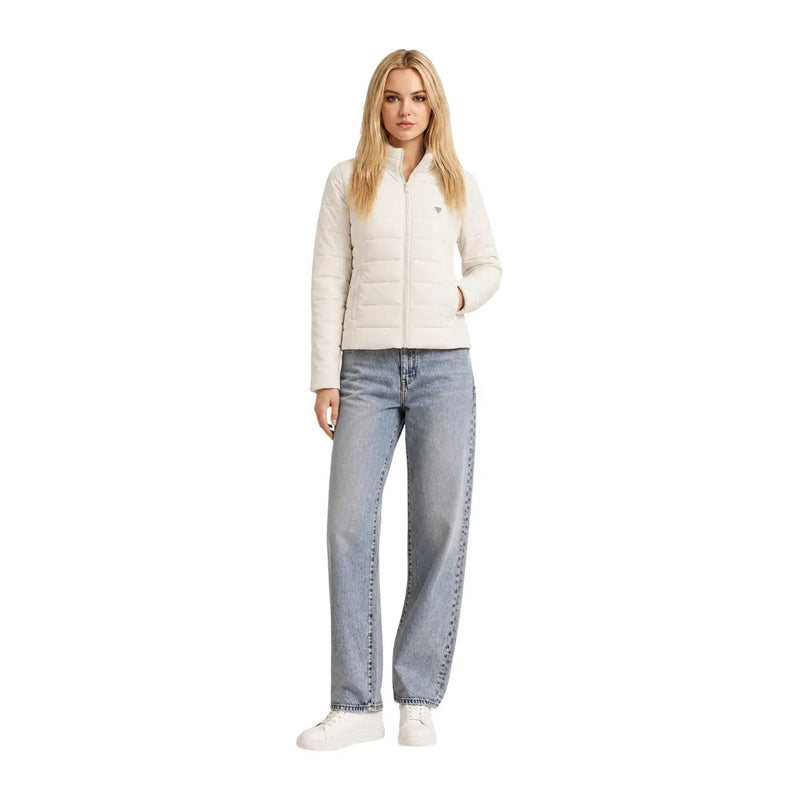 A woman wears a guess women white heavy turtleneck jacket made of quilted polyester with zipper front and subtle logo