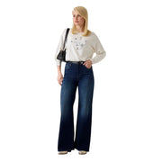 Dark blue wide-leg denim jeans with high-rise waistband and subtle thigh fading paired with guess women white knitwear batwing viscose blend sweater
