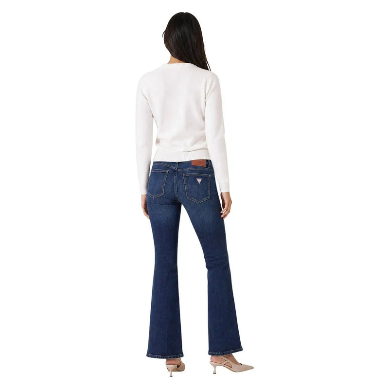 Back side of dark blue denim flare jeans with brown leather patch and white triangular logo paired with guess women white knitwear sweater viscose blend