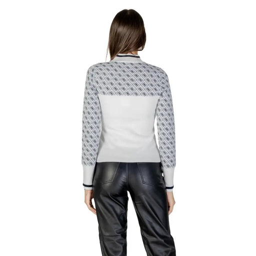 Woman wearing Guess White Long Print Knitwear and black leather pants for fall winter style