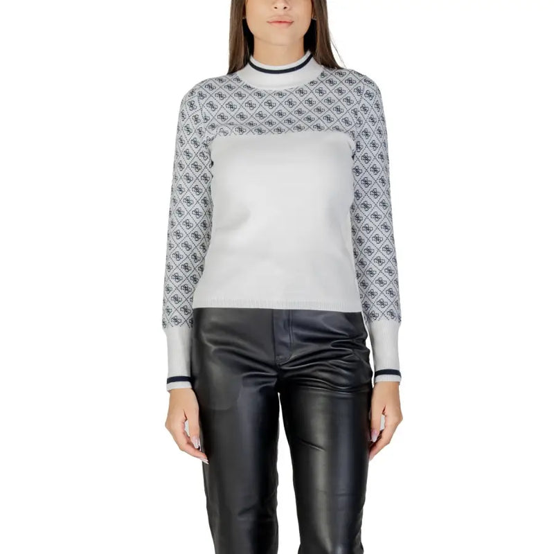 White long-sleeved turtleneck knitwear with patterned upper and solid lower paired with black faux leather pants