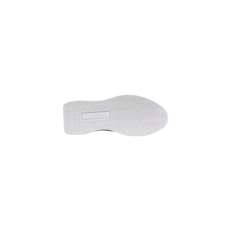 Back side of white rubber sole with textured wavy pattern and Guess embossed label on women platform sneakers spring summer collection