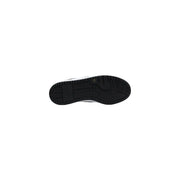 Black rubber sole with white midsole and textured tread of Guess women white polyurethane lace up sneakers visible from back