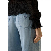 Back side of light-wash blue Guess women wide loose lyocell blend jeans with classic triangular logo patch pocket