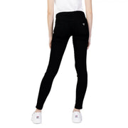 The back side of Guess women’s black skinny jeans with pockets featuring a subtle Guess logo on the back pocket
