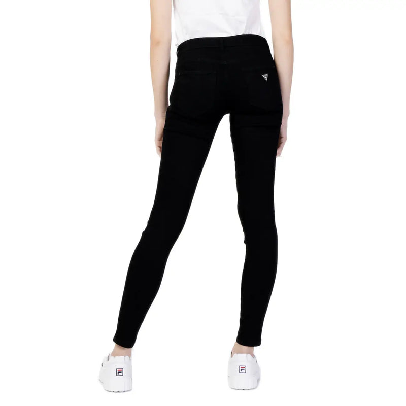 The back side of Guess women’s black skinny jeans with pockets featuring a subtle Guess logo on the back pocket