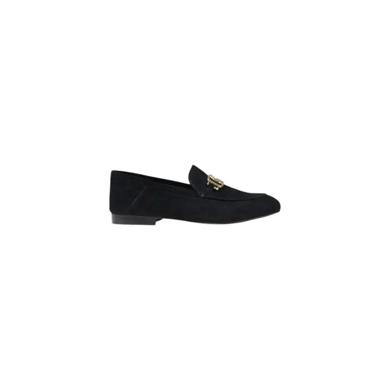 Guess women’s black leather moccasin flats featuring a black suede loafer design with gold-tone metal buckle detail
