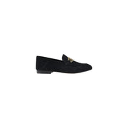 Guess women’s black leather moccasin flats featuring a black suede loafer design with gold-tone metal buckle detail