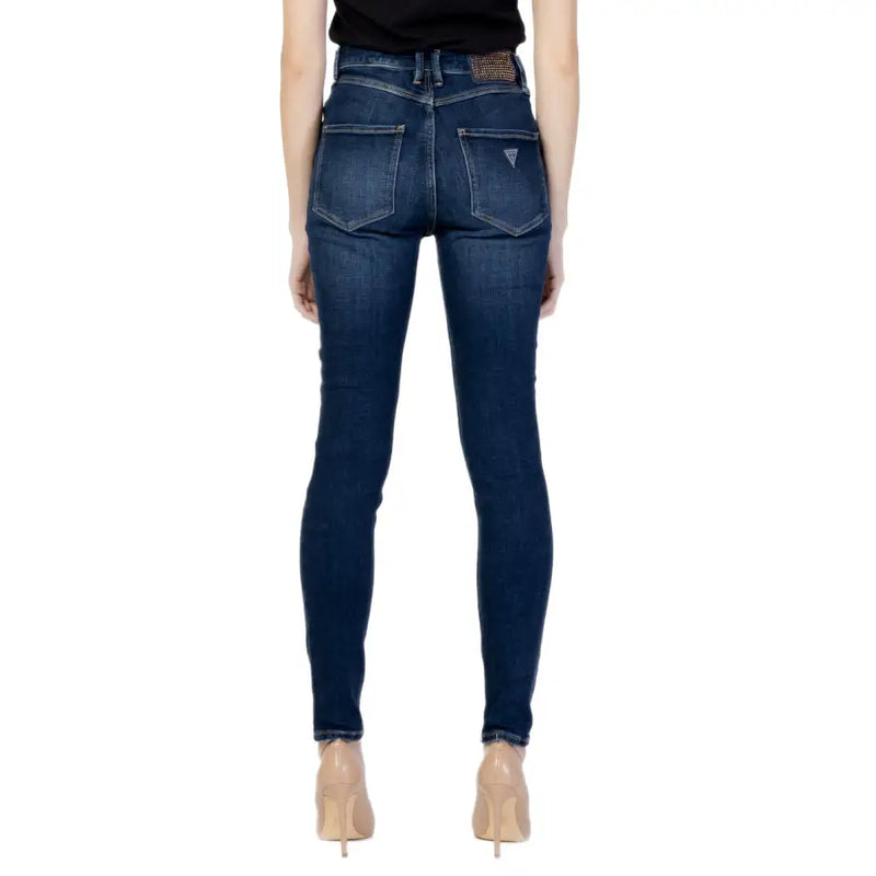 Dark blue denim guess womens jeans with fitted cut subtle fading and logo on the back pocket shown from the back side