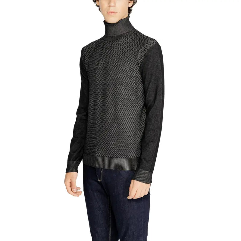 Black and gray textured sweater with ribbed cuffs and hem, likely made of wool or cotton blend.