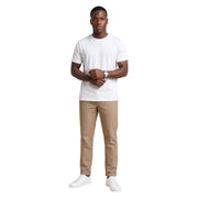 A man wearing hydra men beige striped cotton trousers paired with a white short-sleeved crew neck t-shirt and white sneakers