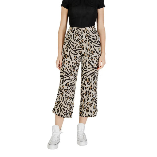 Beige leopard print viscose wide leg cropped trousers paired with a ribbed black top and white platform sneakers