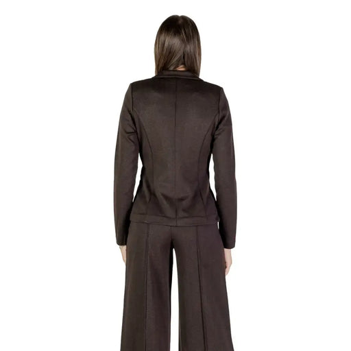 Women’s dark brown pantsuit featuring a low cut V neck long blazer for Fall Winter fashion