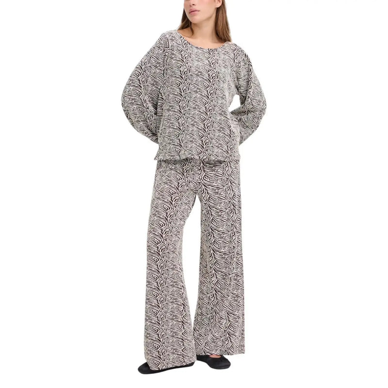 A matching two-piece loungewear set in soft flowing fabric with abstract black and white wavy pattern from ichi women brown print trousers fall winter collection