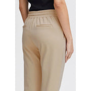 Beige high-waisted ichi women trousers with elastic waistband lace front pockets and two back pockets shown from the back