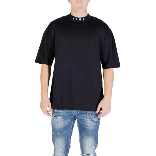 Men’s black oversized T-shirt with mock neck paired with distressed blue jeans