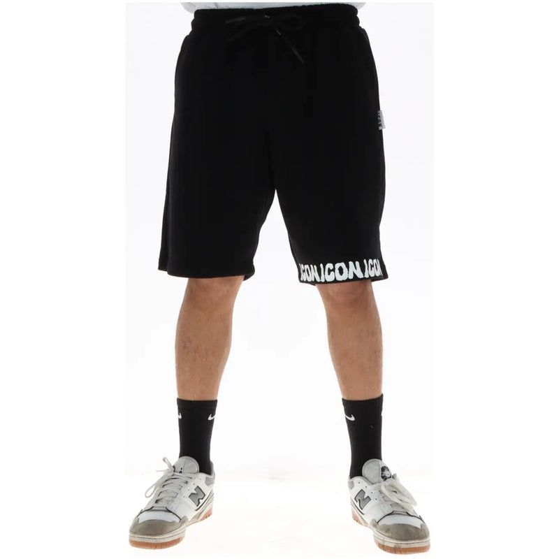 Icon shorts for men in black with white iconic lettering along hem and drawstring, front view