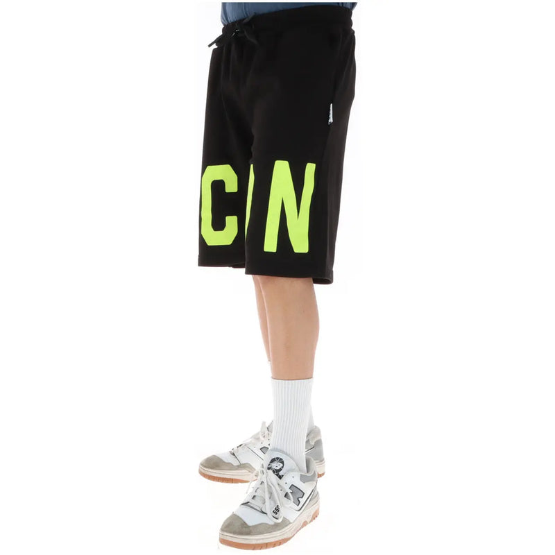 Icon shorts icon for men in black with bold neon green cin lettering on outer leg, side view
