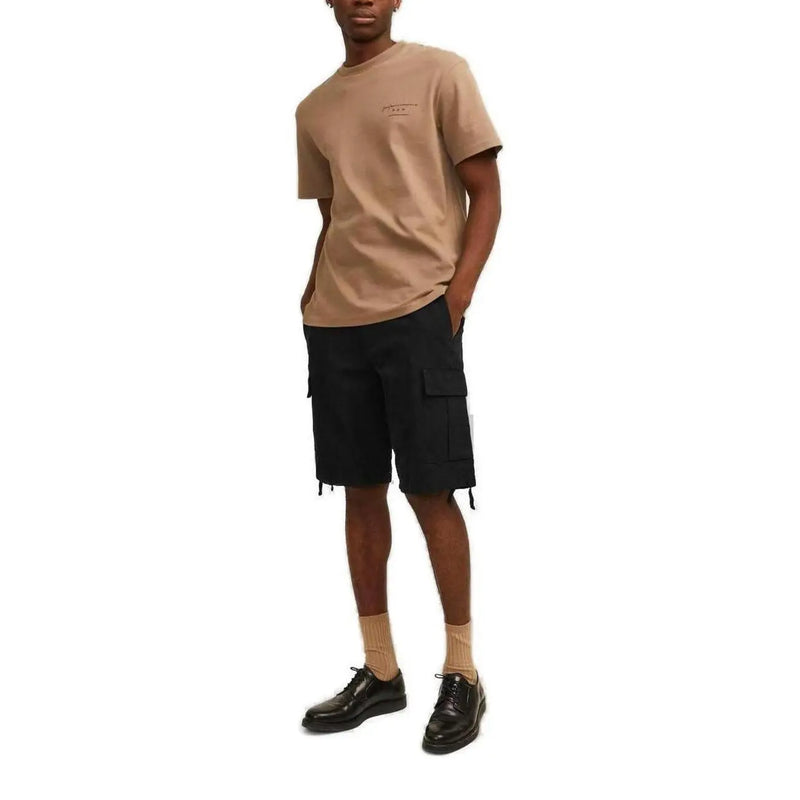 Beige short-sleeved cotton t-shirt with small embroidered logo paired with black cotton jack & jones men shorts with pockets