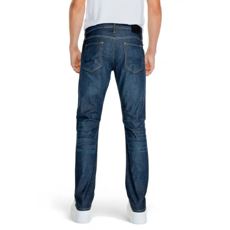 Dark blue slim fit jeans with distressed details and a classic five-pocket design.