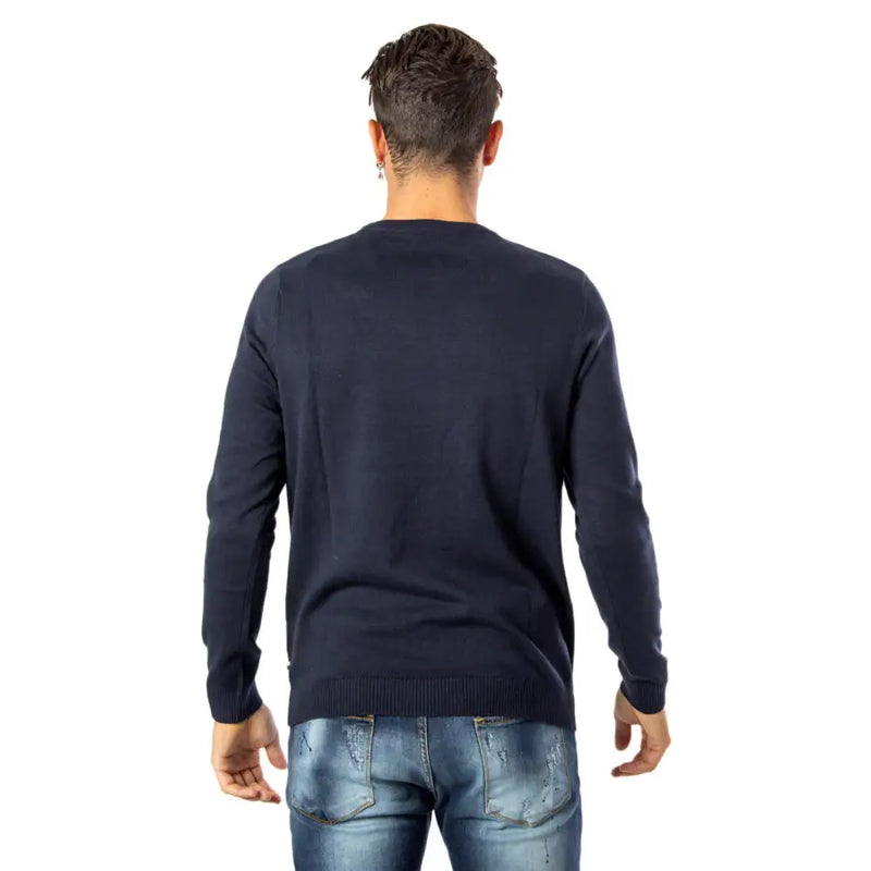 Navy blue crew neck sweater with ribbed cuffs and hem, likely made of cotton or a similar soft material.