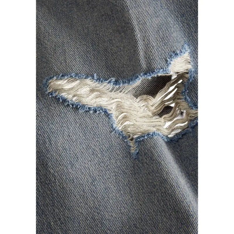 Distressed denim jeans with a tear in the knee area, featuring light blue wash and frayed edges.