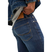Back side of jack and jones men blue plain stretch jeans 12110056 with dark blue denim and tan stitched back pockets