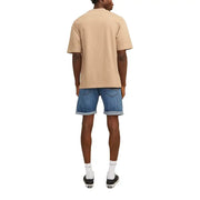 Beige oversized short-sleeved t-shirt with relaxed fit paired with jack & jones men’s blue shorts with pockets