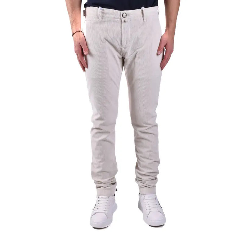 Men’s slim-fit light beige cotton modal blend trousers with white sneakers